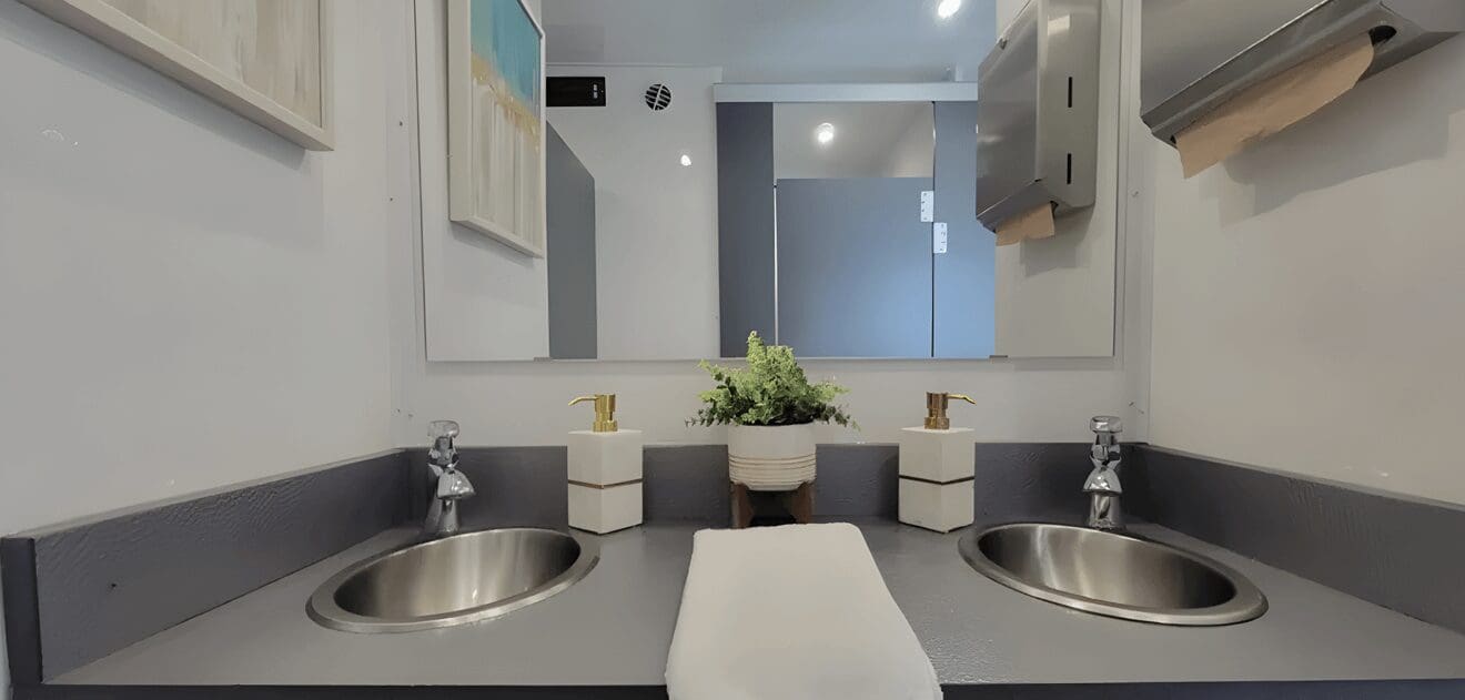 A bathroom with two sinks and mirrors.